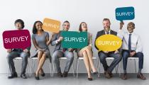 People holding survey signs